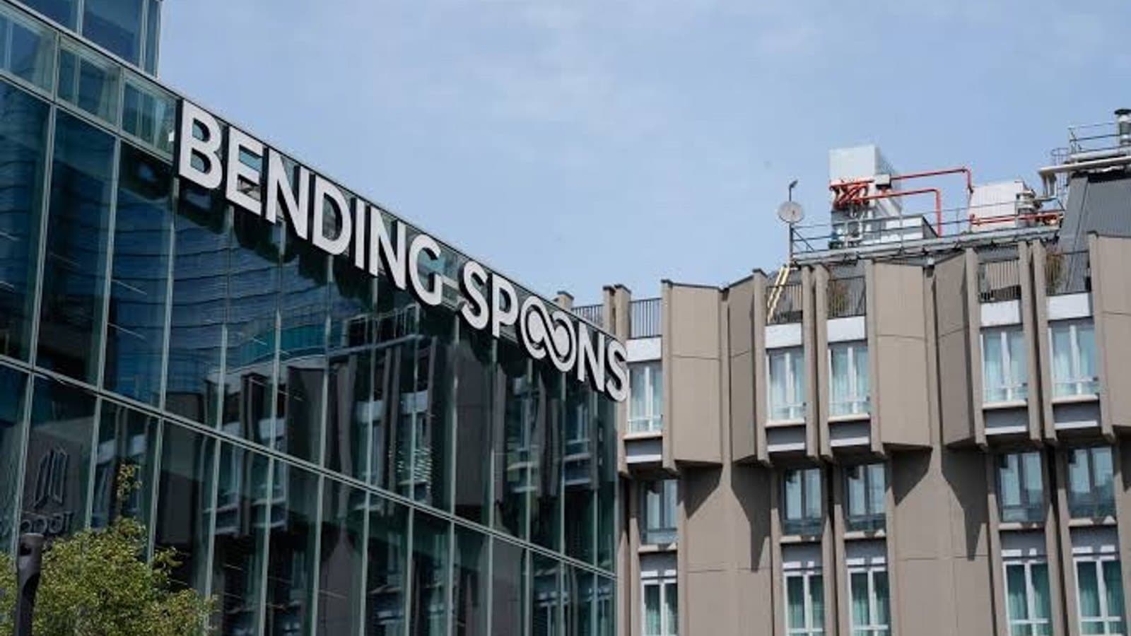 The Bending Spoons name and logo mounted on the glass facade of the company's Milan headquarters.